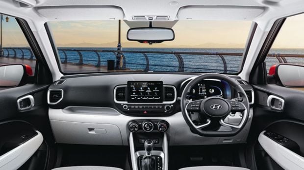 The interior features a large touchscreen infotainment system with connected car tech, wireless charger, AC vents for the rear, and more.