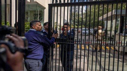 Private security guards close the gate of a building housing BBC office in New Delhi, India, Tuesday, Feb. 14, 2023. (AP Photo/Altaf Qadri)
