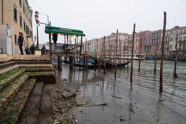 Gondolas are docked along a canal during a low tide in Venice, Italy. Some of Venice's secondary canals have practically dried up lately due a prolonged spell of low tides linked to a lingering high-pressure weather system. (AP Photo)
