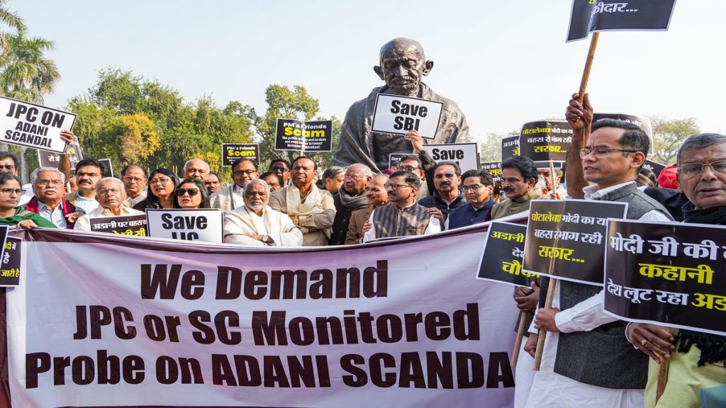 Opposition parties' MPs stage a protest over Adani row at the Gandhi statue in the Parliament complex, in New Delhi, Monday, Feb. 6, 2023. (PTI Photo)
