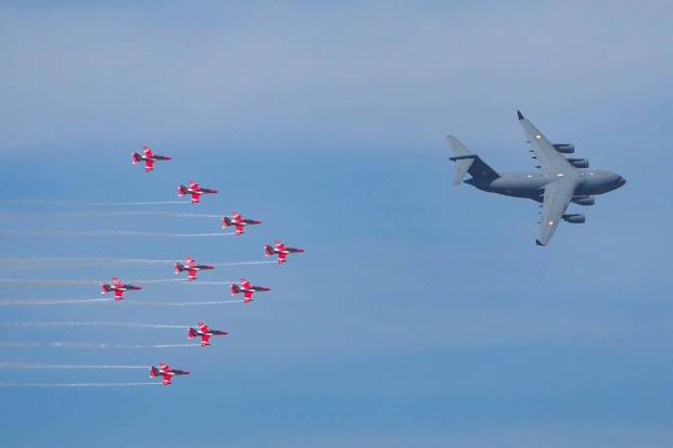 Bengaluru: Indian Air Force's C17 Globemaster flanked by the 'Suryakiran' aerobatic team during the full dress rehearsal of Aero India 2023 at Yelahanka Air base in Bengaluru. (PTI Photo)