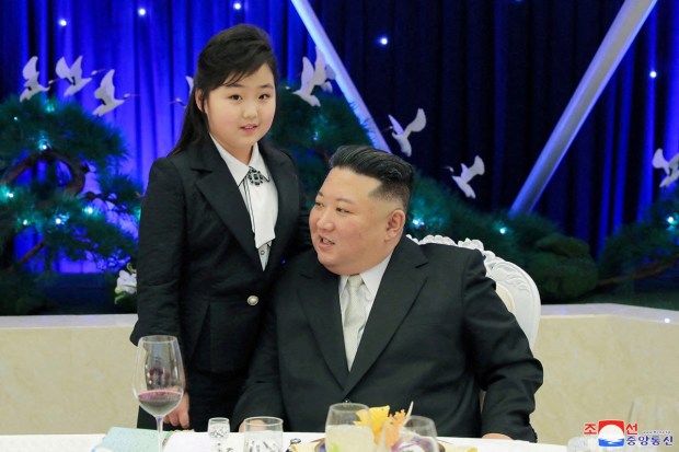In her fourth known public appearance, Kim's daughter Kim Ju Ae, believed to be 9 or 10 years old, stood closely with her father as he shook the hands of senior officials and sat next to him at a table. (Reuters Photo)