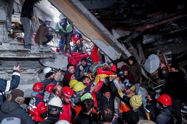 Rescuers carry out a person from the rubble, as the search for survivors continues, in the aftermath of a deadly earthquake, in Hatay, Turkey on Feb 10, 2023. (Image: Reuters/Kemal Aslan)