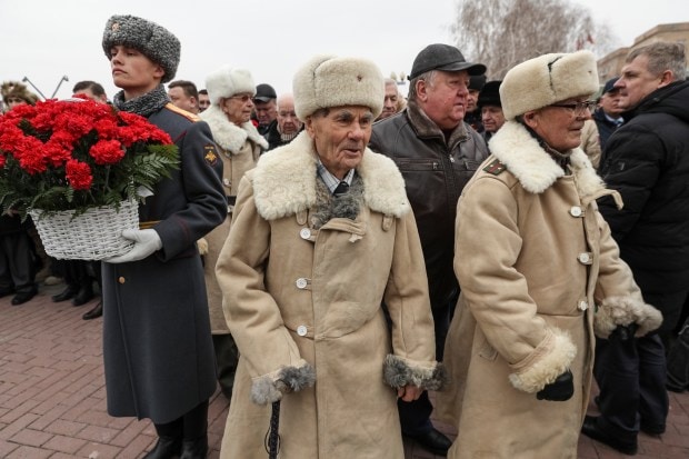 A group of Soviet veterans dressed in Red Army World War II winter uniforms arrive to take a part in an opening of the busts of Soviet leader Josef Stalin, Soviet Marshal Georgy Zhukov, Marshal of the Soviet Union Aleksandr Vasilevsky on the territory of the museum-panorama 