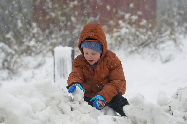 Reid Kauzer, 4, plays with the snow while visiting Mount Diablo State Park in Walnut Creek, Calif., Monday, Feb. 27, 2023. In California, the National Weather Service said a series of winter storm systems will continue moving into the state through Wednesday after residents got a brief break from severe weather Sunday. (AP Photo/Godofredo A. Vásquez)