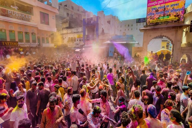 Foreigners as well as locals play with coloured powder to celebrate the festival of Holi in Rajasthan's Pushkar.(PTI photo)