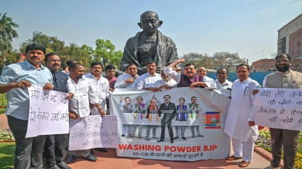 Bharat Rashtra Samithi (BRS) and Aam Aadmi Party (AAP) MPs stage a protest in front of the Gandhi statue over the alleged misuse of Central investigation agencies and demand Joint Parliamentary Committee (JPC) probe on the Adani-Hindenburg issue, at Parliament, in New Delhi on Monday. (ANI Photo)