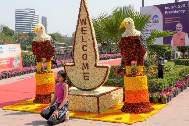 A girl poses for photographs during the inauguration of the G20 Flower Festival. (PTI photo)