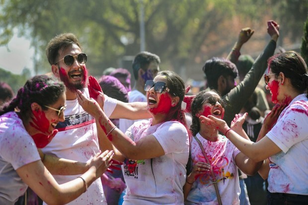 Youngsters play with coloured powder to celebrate the festival of Holi in Chandigarh. (PTI photo)