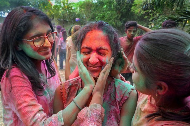 Young women play with colours on the eve of Holi festival in Nagpur. (PTI photo)
