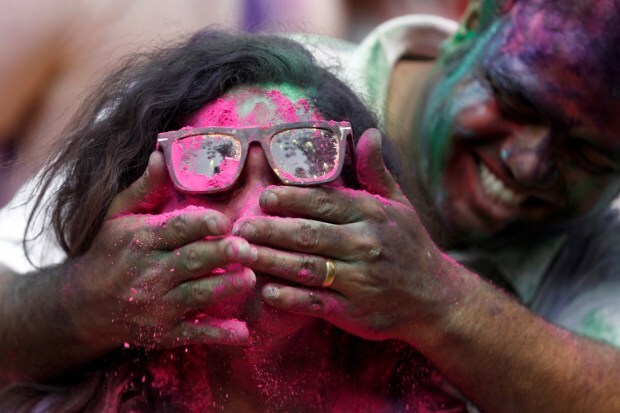 People attend Holi celebrations in Mumbai. (PTI photo)