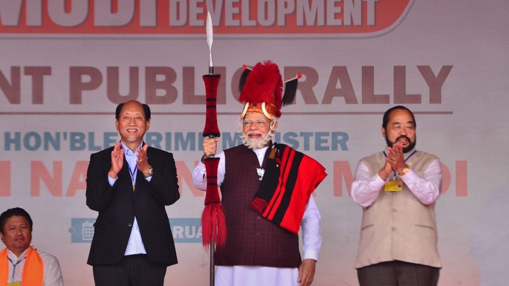 Prime Minister Narendra Modi after being presented with Naga traditional attires by Nagaland Chief Minister Neiphiu Rio (L) during a public rally ahead of the Nagaland Assembly election in Chumukedima, Nagaland, Friday, Feb. 24, 2023. (PTI Photo) Prime Minister Narendra Modi after being presented with Naga traditional attires by Nagaland Chief Minister Neiphiu Rio (L) during a public rally ahead of the Nagaland Assembly election in Chumukedima, Nagaland, Friday, Feb. 24, 2023. (PTI Photo)