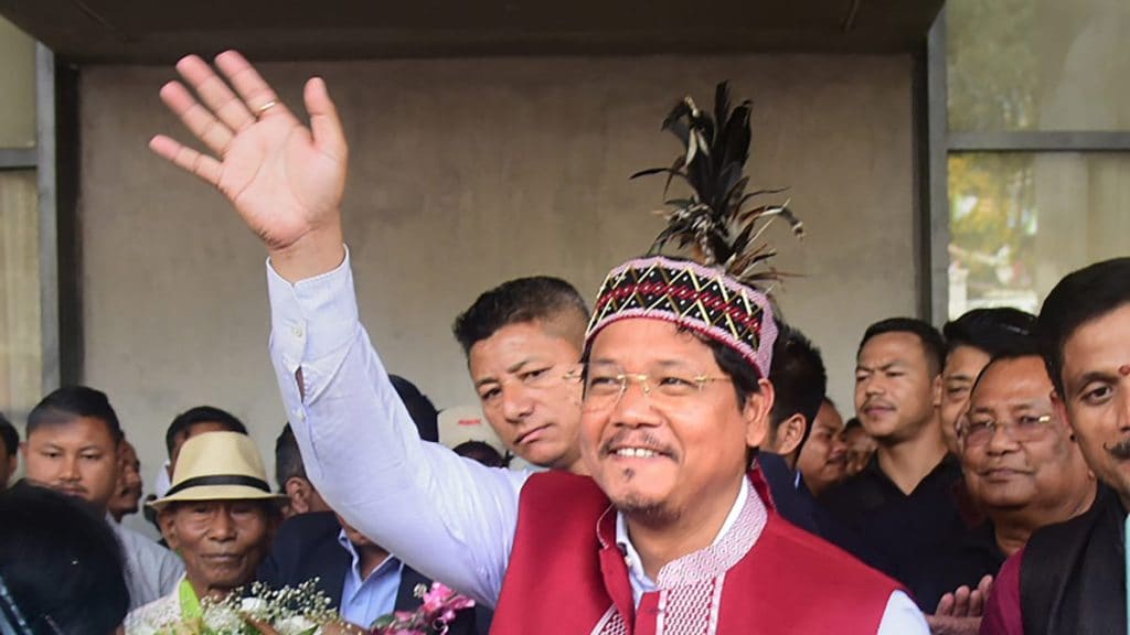 Meghalaya Chief Minister and National People's Party (NPP) chief Conrad Sangma waves at supporters gathered for celebrating his victory in Meghalaya Assembly elections from the South Tura Assembly constituency, Thursday, March 2, 2023. (PTI Photo)