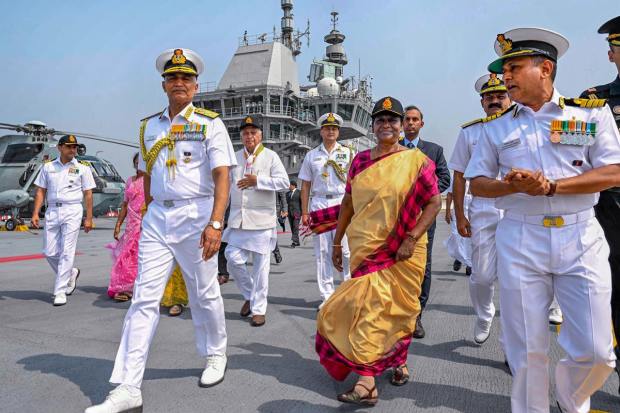 **EDS: IMAGE VIA RB OFFICE** Kochi: President Droupadi Murmu with Chief of the Naval Staff Admiral R. Hari Kumar and others during a visit to the Indigenous Aircraft Carrier INS Vikrant, in Kochi, Thursday, March 16, 2023. (PTI Photo)(PTI03_16_2023_000205B)