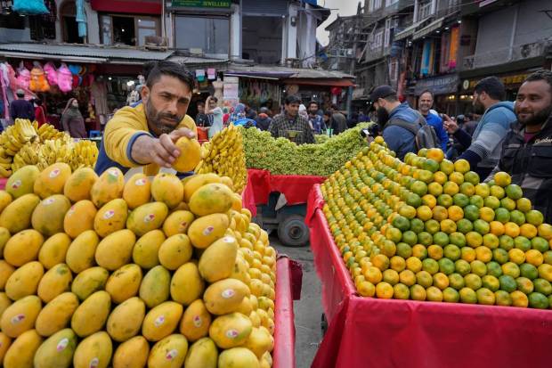 Srinagar: Roadside vendors sell fruits and other items in Srinagar. Muslims throughout the world observe fast from dawn till dusk during this holy month of the Islamic calendar. (PTI Photo)