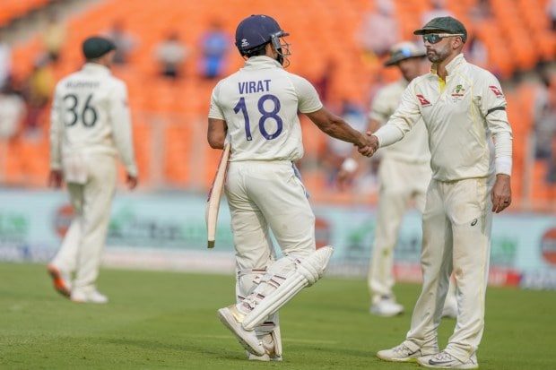Australia's Nathan Lyon, right, greets Virat Kohli as he walks back to pavilion after his dismissal during the fourth day of the fourth cricket test match between India and Australia in Ahmedabad. (Photo: PTI)