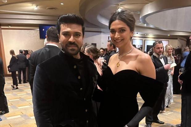 Ram Charan and Deepika Padukone posed together at the red carpet . Ram Charan wore a custom-made Shantanu and Nikhil creation and Deepika Padukone opted for an all-black off-shoulder velvet gown for the prestigious award.
