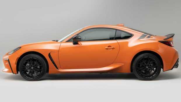 The interior is finished in all-black while the orange theme continues inside as well, on the steering wheel, gear shifter, and handbrakes.