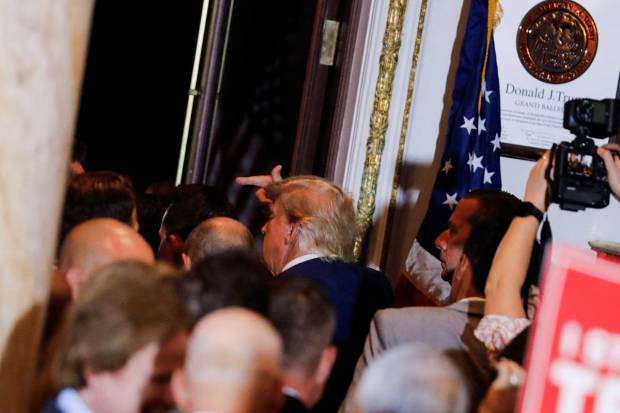 Former U.S. President Donald Trump gestures as he walks next to a crowd after delivering remarks on the day of his court appearance in New York, after being indicted by a Manhattan grand jury following a probe into hush money paid to porn star Stormy Daniels, in Palm Beach, Florida, U.S. REUTERS