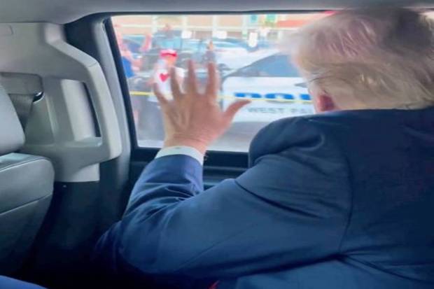 Former U.S. President Donald Trump waves to a crowd en route to his Mar-a-Lago resort, after being indicted by a Manhattan grand jury following a probe into hush money paid to porn star Stormy Daniels, in Palm Beach, Florida, U.S., in this still image from social media video. Instagram/Eric Trump via REUTERS
