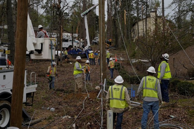 Workers run new power lines in the aftermath of a tornado through the South and Midwest, in Arkansas. (Reuters photo)
