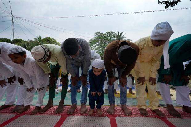 Muslims offer Eid al-Fitr prayer marking the end of the holy fasting month of Ramadan in Guwahati, India. (AP Photo)