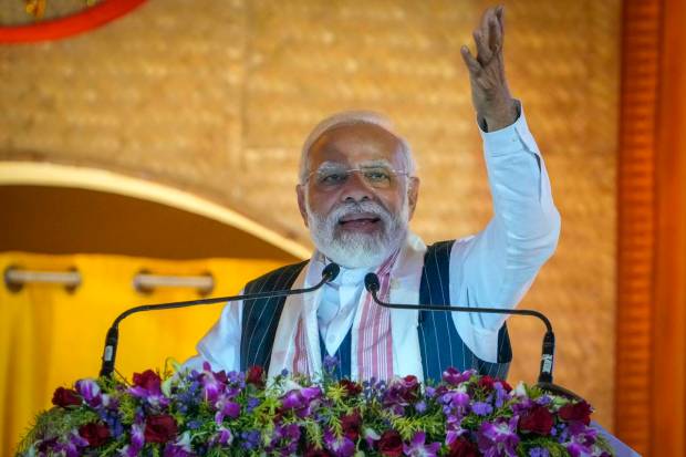 Prime Minister Narendra Modi speaks during an event to attempt Guinness World Record in the largest folk dance performance category in Guwahati, India. Around 11,000 Bihu dancers and musicians performed together to set a new record for Guinness World Record in the largest folk dance performance category. (AP Photo)