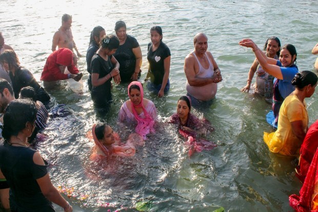 Devotees take a holy dip in the River Ganga on the occasion of Baisakhi festival, at Har Ki Pauri ghat in Haridwar. (Photo: PTI)