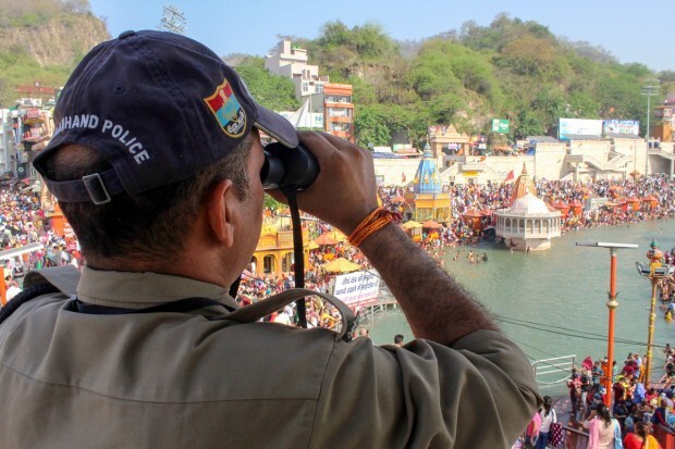A security personnel keeps vigil during the celebrations of Baisakhi festival, at Har Ki Pauri ghat in Haridwar. (Photo: PTI)