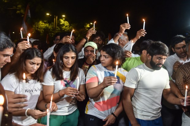 Wrestlers Bajrang Punia, Vinesh Phogat, Sakshi Malik and others participate in a candle march during their protest at Jantar Mantar, New Delhi, on Wednesday. (Photo: PTI)