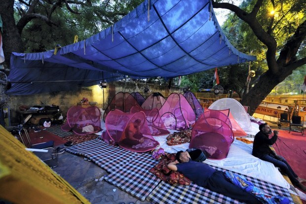 Wrestlers rest under mosquito nets following a night stay at Jantar Mantar amid their protest in New Delhi on Wednesday. (Photo: PTI)