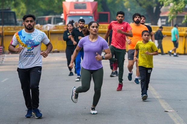 Wrestlers warm up during a training session near Jantar Mantar during their protest in New Delhi on Thursday. (Photo: PTI)