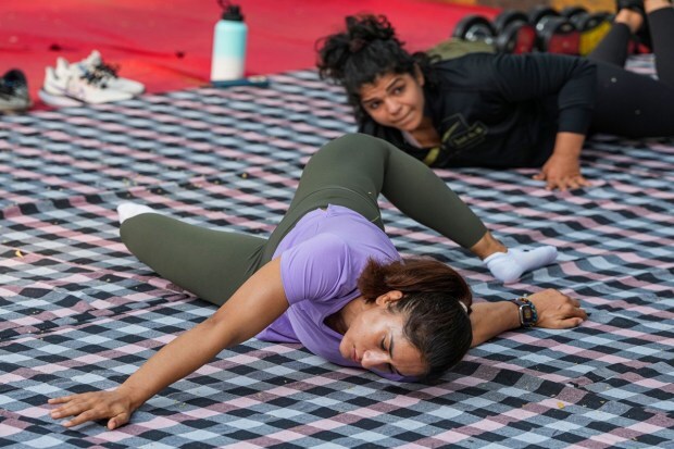 Wrestlers Vinesh Phogat and Sakshi Malik exercise near Jantar Mantar during their protest in New Delhi on Thursday. (Photo: PTI)