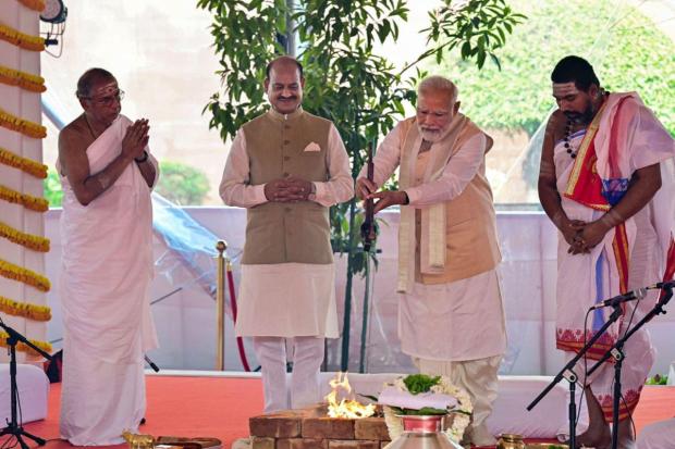 Prime Minister Narendra Modi performs rituals while offering prayers at the inauguration of the new Parliament building. Lok Sabha Speaker Om Birla is also seen. (Image/PTI)