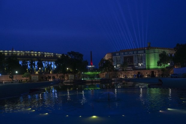 Prime Minister Narendra Modi dedicated the new Parliament House to the nation on Sunday. In the evening, the new building was illuminated with colourful lights. Laser show was also organised at the site. (PTI photo)