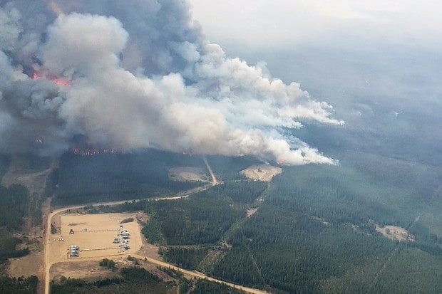 Smoke rises from areas on the southeast side of wildfire EWF-035, part of the Deep Creek Wildfire Complex which is being tackled by helicopters near Shining Bank, Alberta, Canada (Reuters)