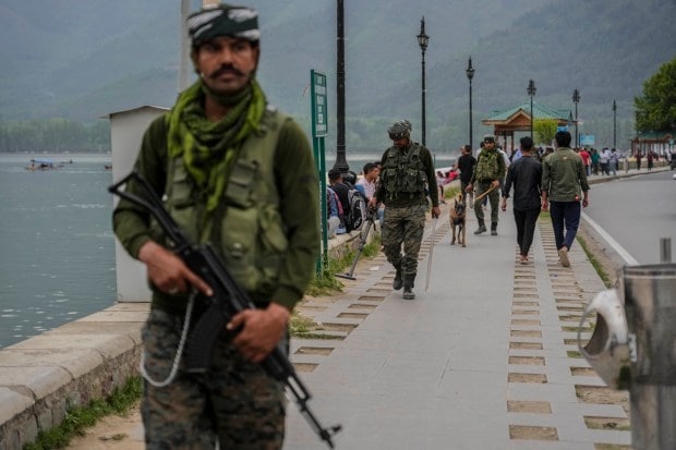 Paramilitary soldiers guard near the Dal Lake ahead of G20 tourism working group meeting in Srinagar. Securities have been tightened to prevent any terror attack (AP Photo)