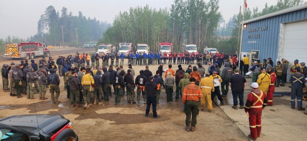 Firefighters gather for a morning briefing at Rainbow Lake Fire Hall before heading out to tackle the Long Lake wildfire HWF036, in Rainbow Lake, Alberta, Canada. ((Reuters)