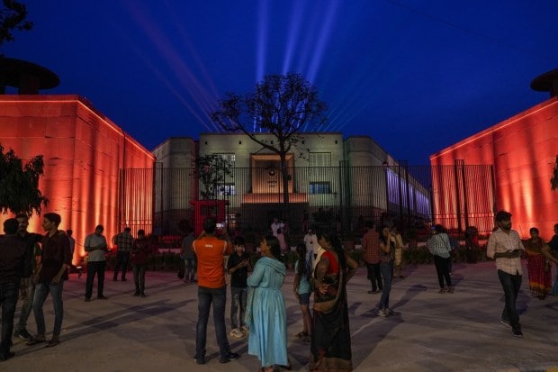 People visit the new Parliament building on Sunday evening after its inauguration. (PTI photo)