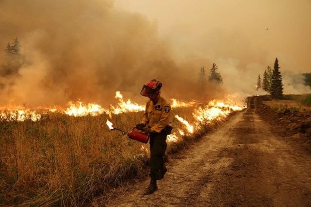 A firefighter conducts a controlled ignition on the Sturgeon Lake Wildfire Complex GCX001 near Valleyview, Alberta, Canada. (Reuters)