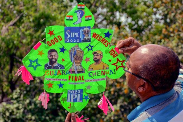 Kitemaker Jagmohan Kanojia in Amritsar displays a kite adorned with images of Gujarat Titans captain Hardik Pandya and Chennai Super Kings captain Mahendra Singh Dhoni on the eve of the IPL 2023 final. (Image/PTI)