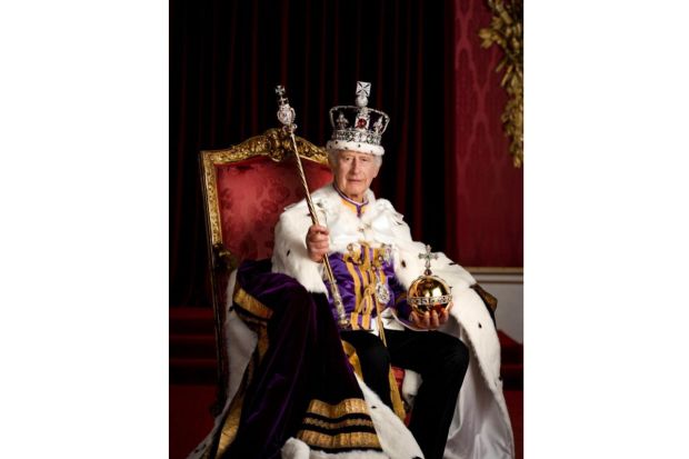 Britain's King Charles III poses for a photo in full regalia in the Throne Room, London. The King is wearing the Robe of Estate, the Imperial State Crown and is holding the Sovereign's Orb and Sovereign's Sceptre with Cross.