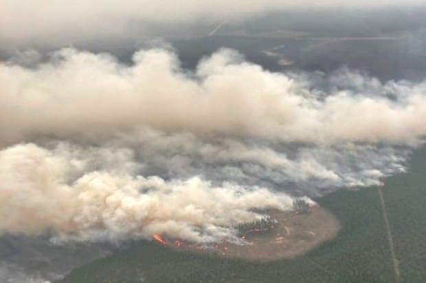 Smoke rises from wildfire EWF-031, part of the Pembina Wildfire Complex east of Minnow Lake near Edson, Alberta, Canada (Reuters)
