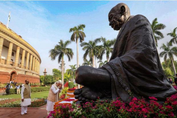 Prime Minister Narendra Modi pays floral tribute to Mahatma Gandhi at Parliament House. (Image/PTI)