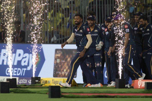 Gujrat Titans' captain Hardik Pandya steps into the ground with his team before the start of the Indian Premier League qualifier cricket match between Chennai Super Kings and Gujrat Titans in Chennai, India, Tuesday. (AP Photo)