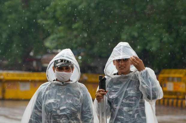 New Delhi: Central Reserve Police Force personnel wearing raincoats during rain at Jantar Mantar, in New Delhi. (PTI Photo)