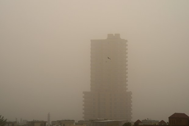 A building is pictured through dust as the air quality deteriorates, in New Delhi. (PTI photo)