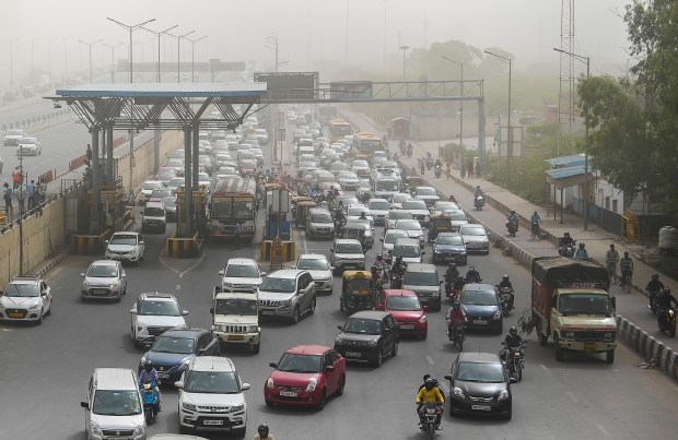 Vehicles stuck in traffic jam as the air quality deteriorates due to dust pollution in the national capital. (PTI photo)