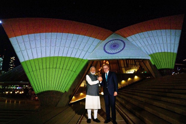 Prime Minister Narendra Modi with Australian Prime Minister Anthony Albanese at Sydney Opera House, illuminated in Indian tricolours, in Sydney on Wednesday. (Image/PTI)