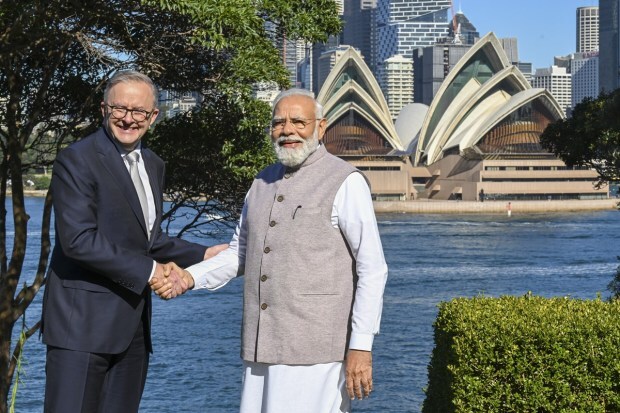 Prime Minister Narendra Modi with Australian Prime Minister Anthony Albanese pose for photographs against the backdrop of the Sydney Opera House following a bilateral meeting at Admiralty House in Sydney. Modi struck new agreements with Albanese on migration and green hydrogen, while raising concerns about attacks on Hindu temples in Sydney. (Image/AP)